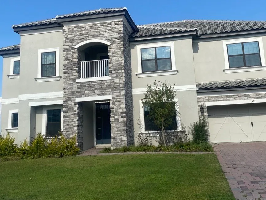 Two-storey home with stone facade and tile roof, Central Florida